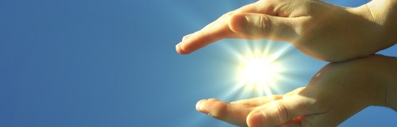 hand sun and blue sky with copyspace showing freedom or solar power concept